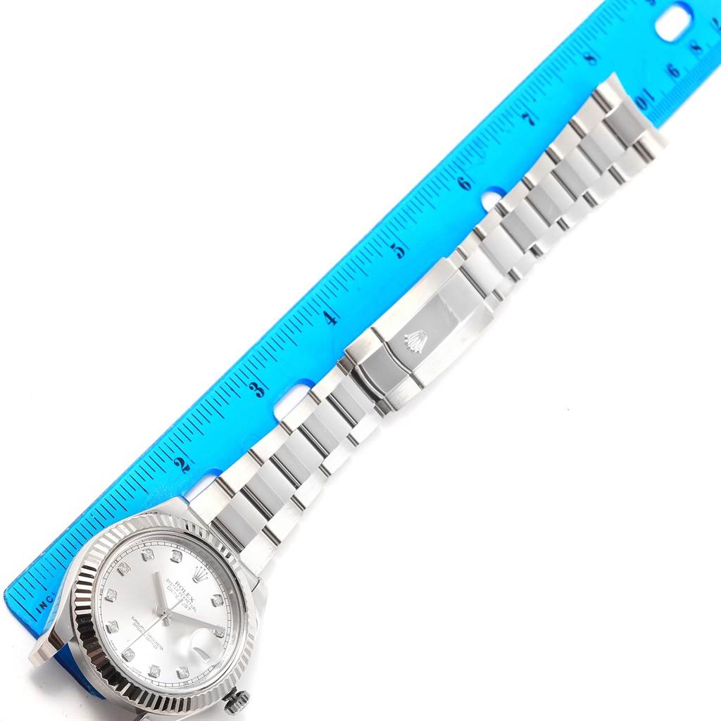 The image shows a Rolex Datejust 41 116334 Men's Stainless Steel Silver Dial 116334 Men's Stainless Steel Silver Dial watch laid next to a blue ruler, highlighting the case, dial, and bracelet.