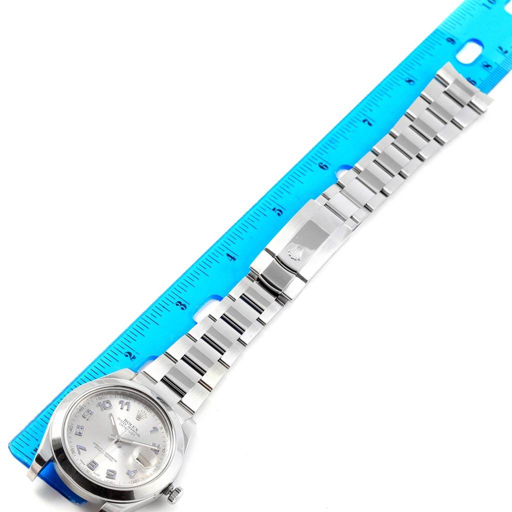 This image shows a top view of the Rolex Datejust 41 116300 Men's Stainless Steel Silver Dial 116300 Men's Stainless Steel Silver Dial watch, including its silver dial, bracelet, and clasp next to a ruler.