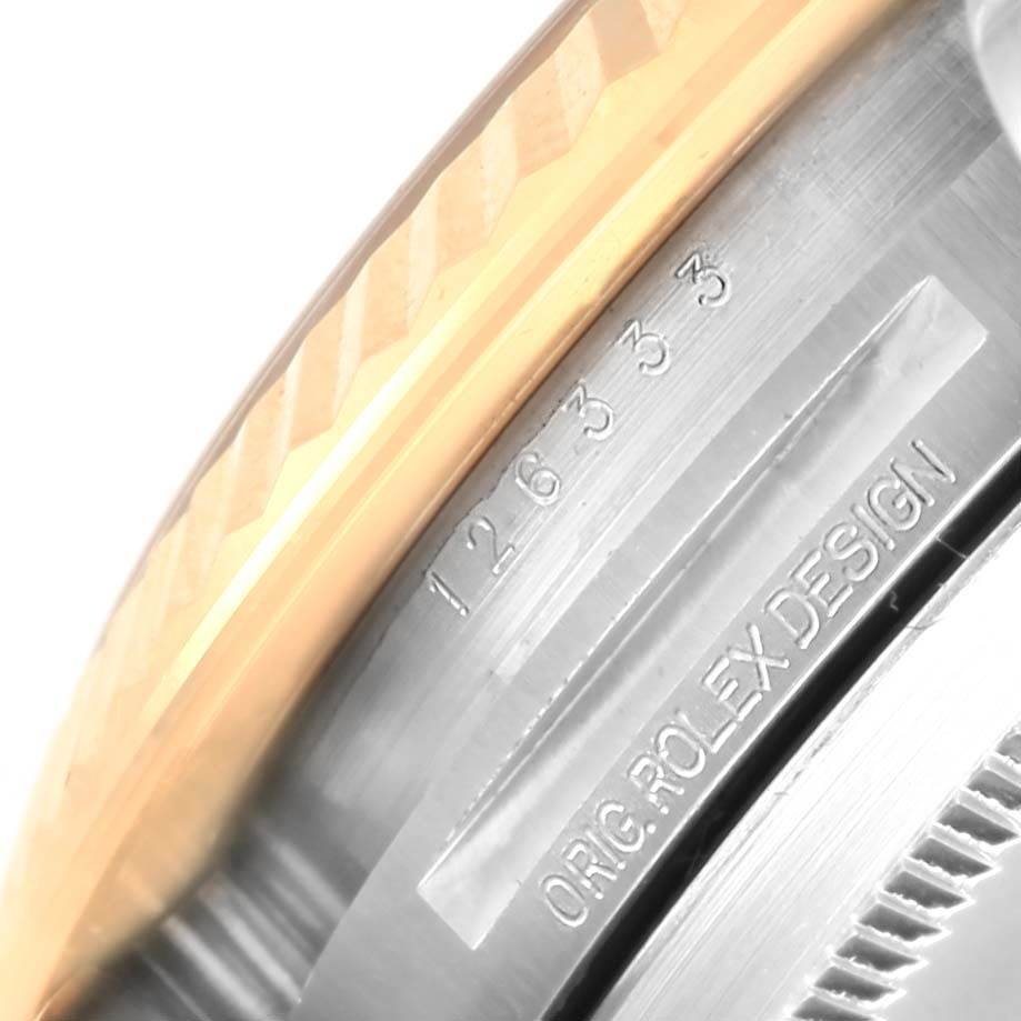 This close-up image shows part of the bezel and the serial number engraving on a Rolex Datejust 41 126333 Men's Steel and Gold (two tone) Champagne Dial 126333 Men's Steel and Gold (two tone) Champagne Dial model.