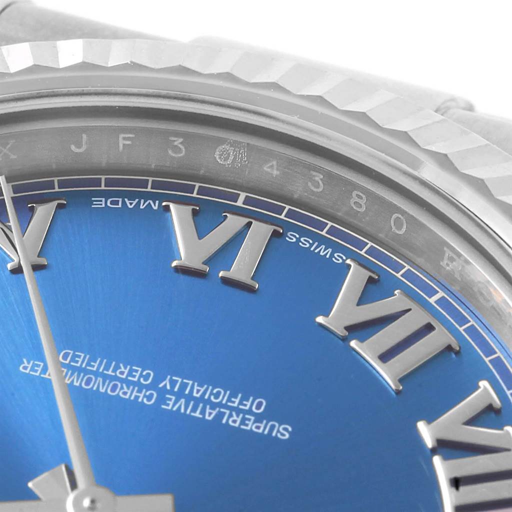 The image shows a close-up of the Rolex Datejust 41 116334 Men's Stainless Steel Blue Dial 116334 Men's Stainless Steel Blue Dial watch face, focusing on the bezel, blue dial, and Roman numerals.