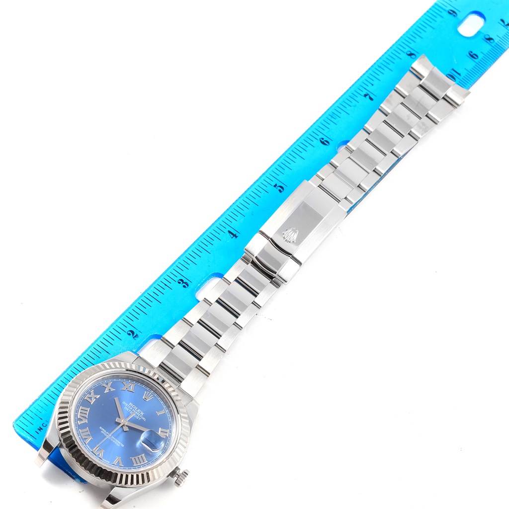 The image shows a Rolex Datejust 41 116334 Men's Stainless Steel Blue Dial 116334 Men's Stainless Steel Blue Dial model watch laid flat next to a ruler, displaying the face, band, and clasp.