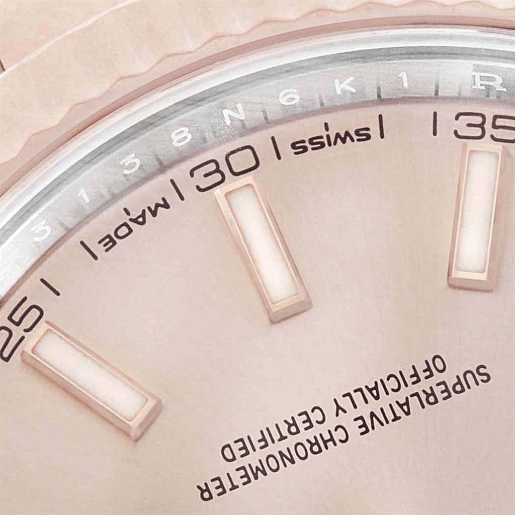 The image shows a close-up of the dial and part of the bezel of a Rolex Datejust 41 126331 Men's Steel and Gold (two tone) Pink Dial 126331 Men's Steel and Gold (two tone) Pink Dial, highlighting the hour markers and text.