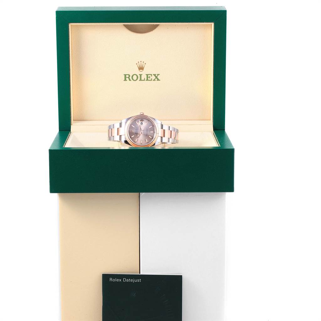 The Rolex Datejust 41 126331 Men's Steel and Gold (two tone) Pink Dial 126331 Men's Steel and Gold (two tone) Pink Dial watch is shown front-facing in its open green and cream-colored box with its manual at the base.