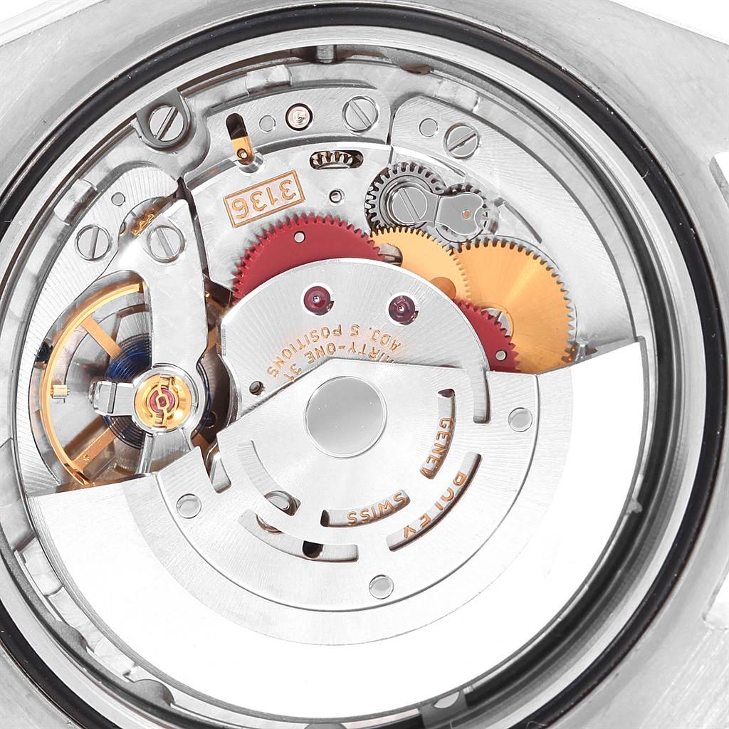 The image shows the internal mechanisms of a Rolex Datejust 41 116334 Men's Stainless Steel Blue Dial 116334 Men's Stainless Steel Blue Dial watch from a back angle, revealing its intricate gears and movement components.