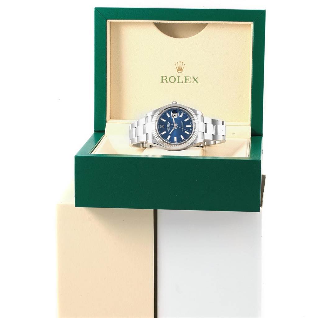 The Rolex Datejust 41 116334 Men's Stainless Steel Blue Dial 116334 Men's Stainless Steel Blue Dial watch is shown from the front, lying flat inside its open green box.