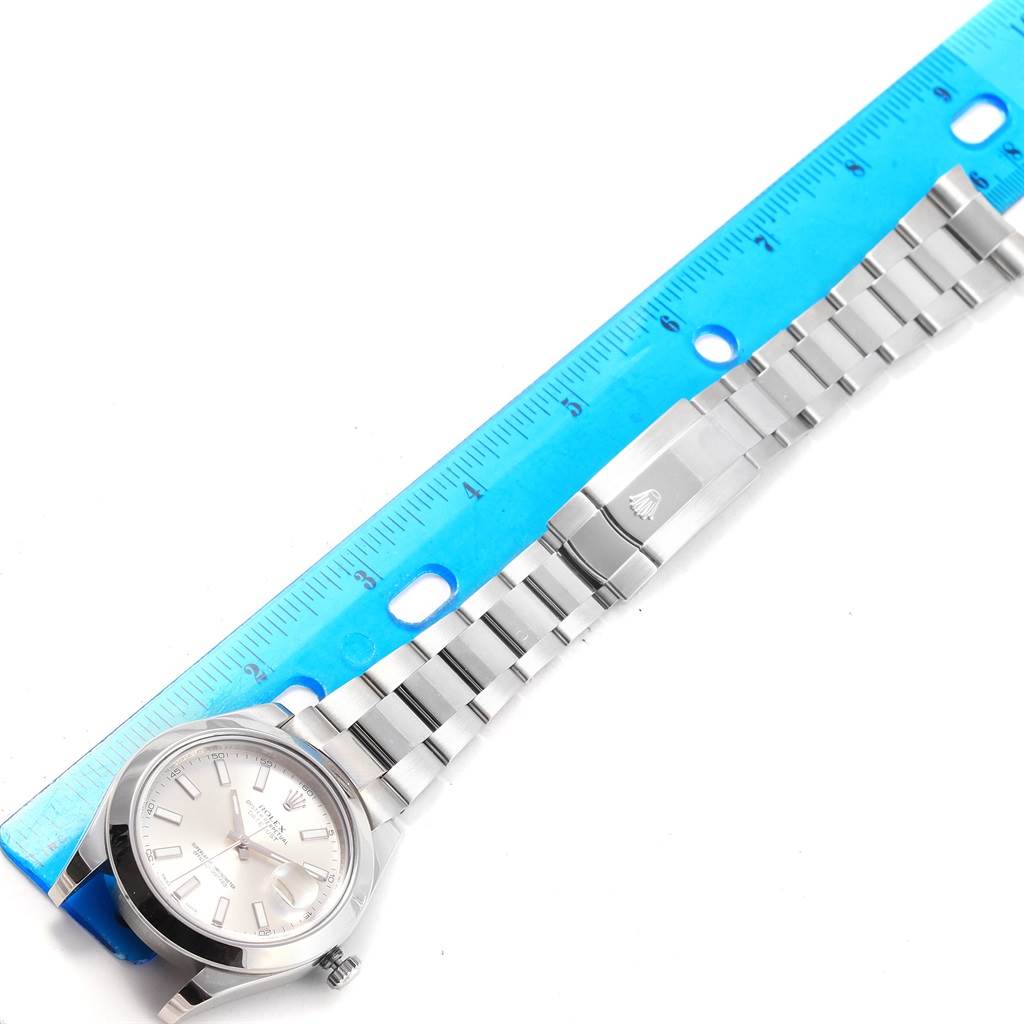 The image shows a Rolex Datejust 41 116300 Men's Stainless Steel Silver Dial 116300 Men's Stainless Steel Silver Dial watch laid flat, displaying the face, bracelet, and clasp next to a blue ruler.