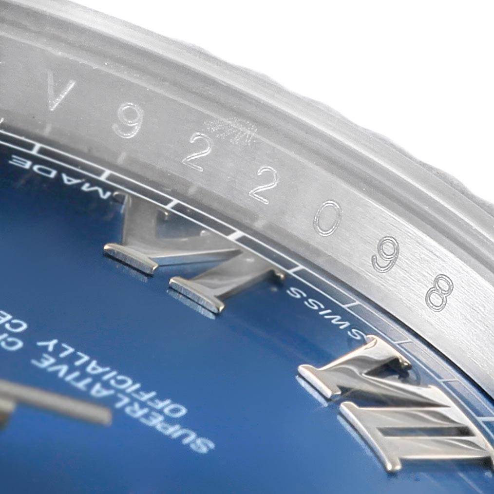 This image shows a close-up of the bezel and part of the dial of a Rolex Datejust 41 116334 Men's Stainless Steel Blue Dial 116334 Men's Stainless Steel Blue Dial watch.