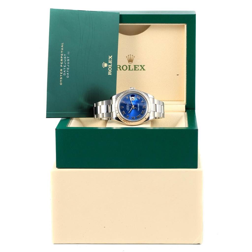 The Rolex Datejust 41 116334 Men's Stainless Steel Blue Dial 116334 Men's Stainless Steel Blue Dial watch is displayed front-facing in an open box, accompanied by a booklet.