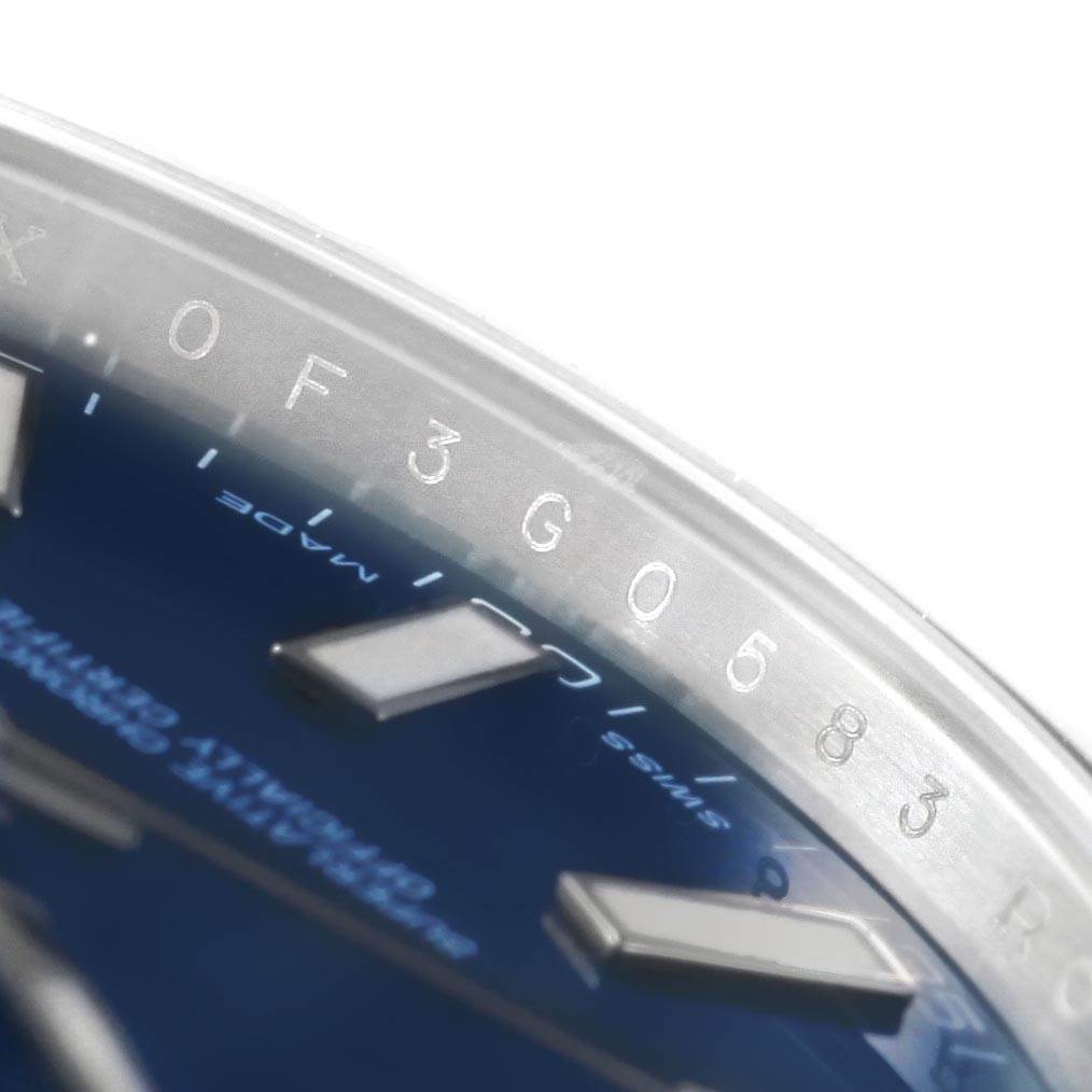 The image shows a close-up of the dial and bezel of the Rolex Datejust 41 116334 Men's Stainless Steel Blue Dial 116334 Men's Stainless Steel Blue Dial, highlighting the serial engraving and part of the hour markers.