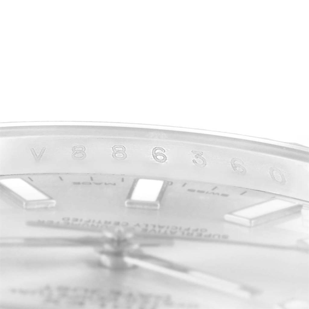 The image shows a close-up of the serial number engraving on the rehaut and part of the dial of a Rolex Datejust 41 116334 Men's Stainless Steel Silver Dial 116334 Men's Stainless Steel Silver Dial watch.