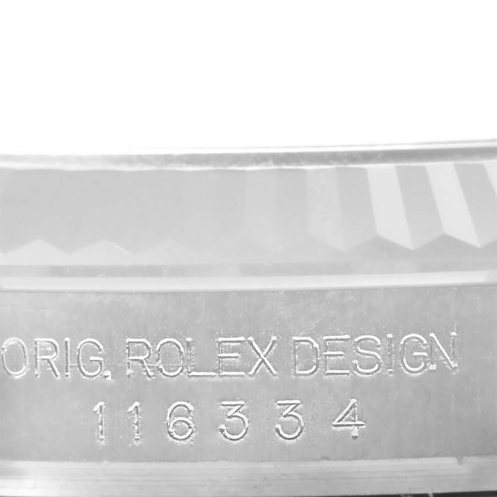 This close-up image of a Rolex Datejust 41 116334 Men's Stainless Steel Grey Dial 116334 Men's Stainless Steel Grey Dial watch shows the engraved "ORIG. ROLEX DESIGN 116334" on its case.