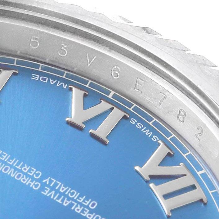 This image shows a close-up of the dial and bezel of the Rolex Datejust 41 116334 Men's Stainless Steel Blue Dial 116334 Men's Stainless Steel Blue Dial watch, highlighting the "VI" numeral and serial numbers.