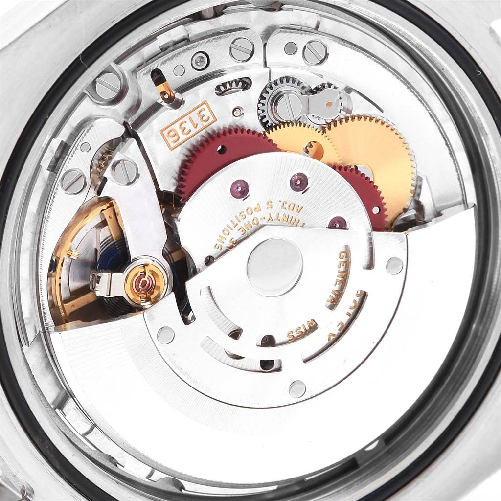 The image shows the internal mechanism of a Rolex Datejust 41 116334 Men's Stainless Steel Blue Dial 116334 Men's Stainless Steel Blue Dial watch, including gears, rotors, and the movement parts from a rear angle.