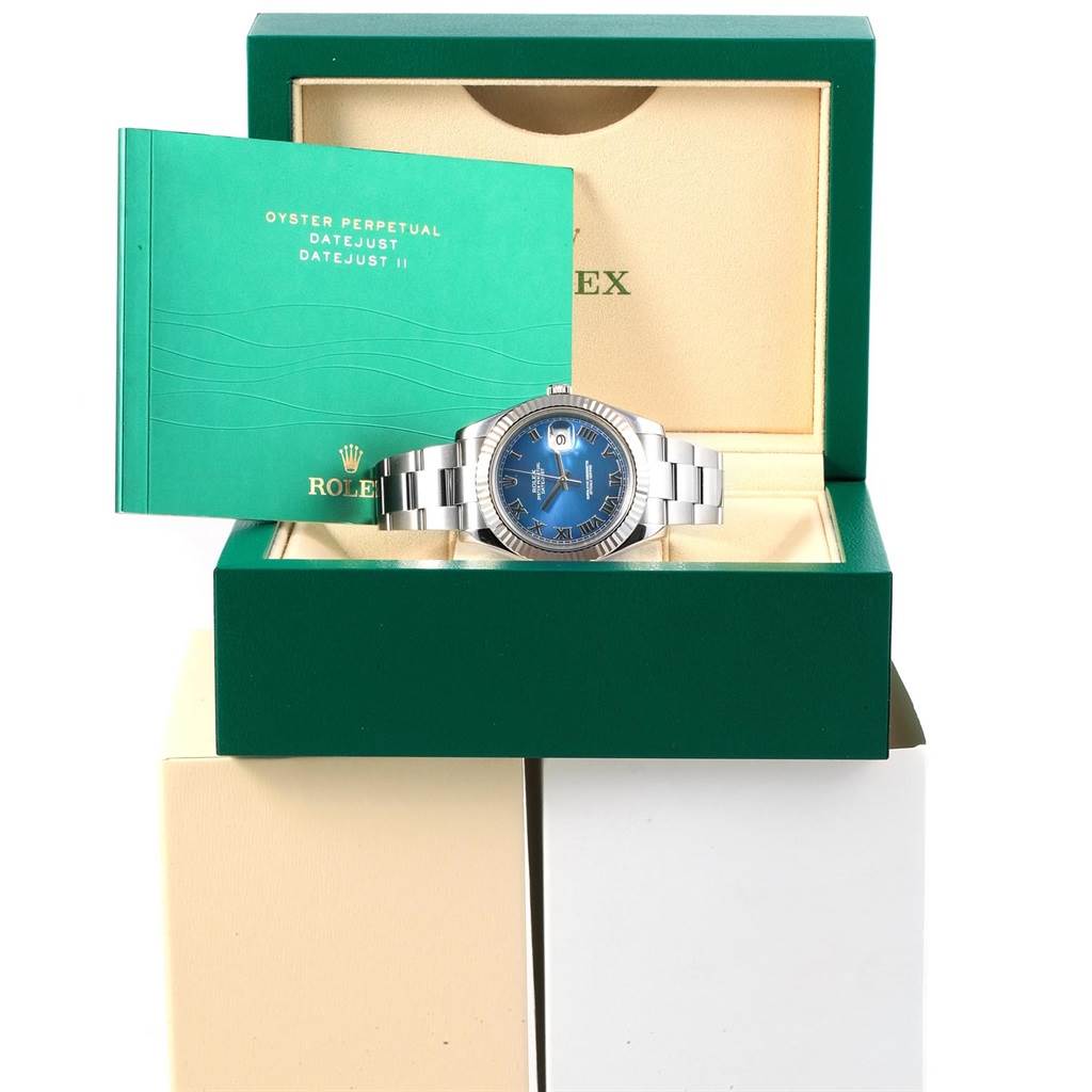 The image shows a Rolex Datejust 41 116334 Men's Stainless Steel Blue Dial 116334 Men's Stainless Steel Blue Dial watch with a blue dial in its box, accompanied by an instruction manual.