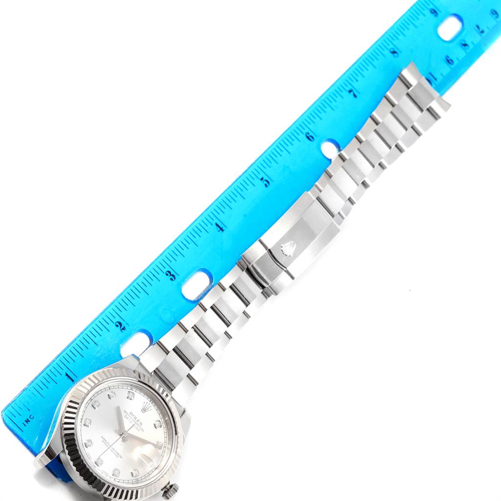 This image displays the Rolex Datejust 41 116334 Men's Stainless Steel Silver Dial 116334 Men's Stainless Steel Silver Dial watch laid flat with a blue ruler measuring its silver bracelet.