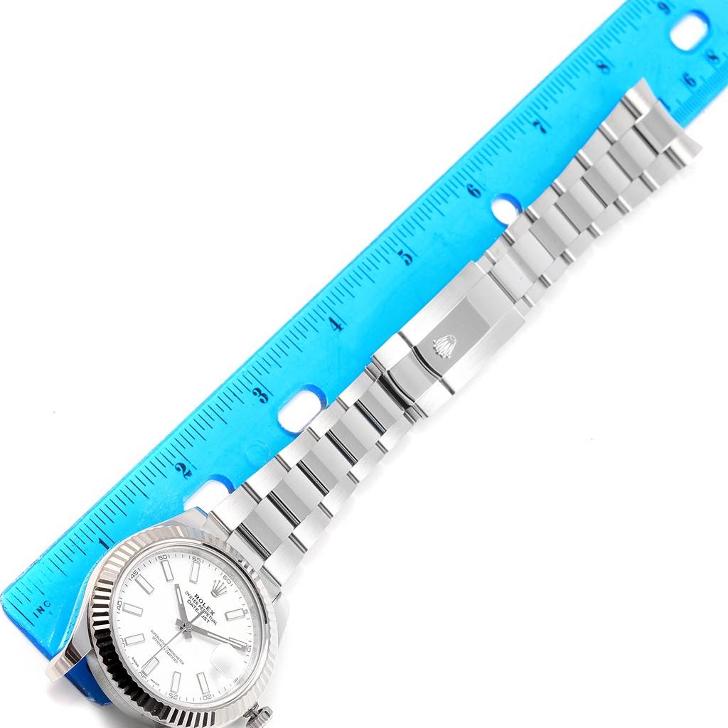 The image shows the Rolex Datejust 41 116334 Men's Stainless Steel White Dial 116334 Men's Stainless Steel White Dial watch laid flat with a ruler measuring its bracelet length.