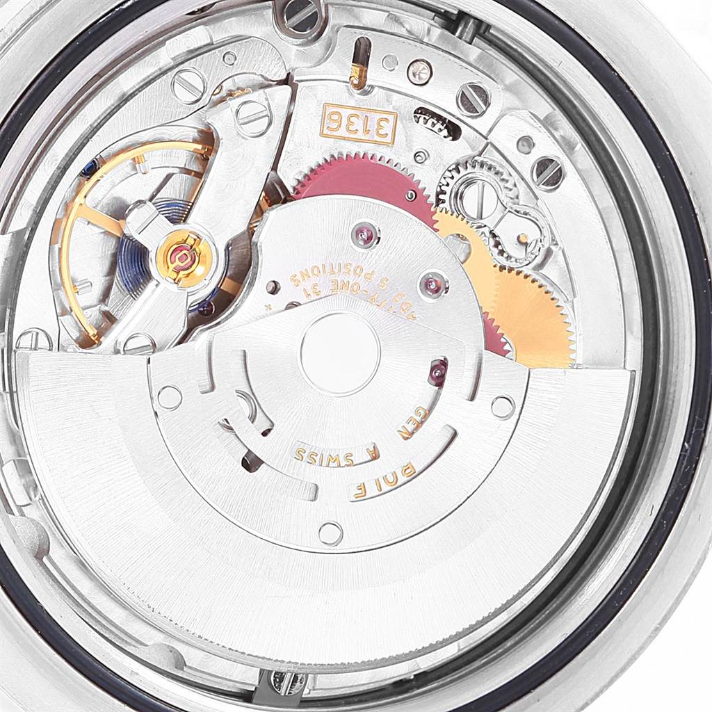 This image shows the intricate inner mechanics of a Rolex Datejust 41 116334 Men's Stainless Steel Black Dial 116334 Men's Stainless Steel Black Dial watch, focusing on its movement and rotor from a top-down angle.