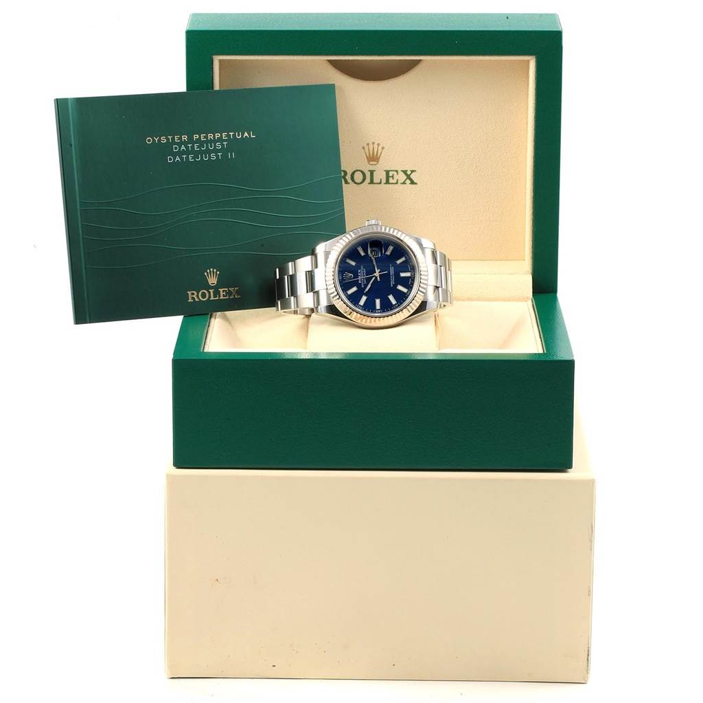 The Rolex Datejust 41 116334 Men's Stainless Steel Blue Dial 116334 Men's Stainless Steel Blue Dial watch is displayed front-on in its box with accompanying booklet propped upright beside it.