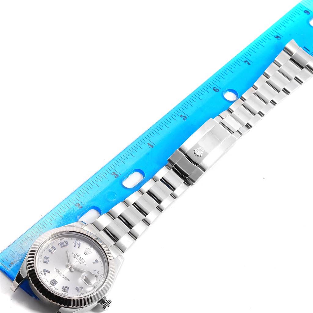 The Rolex Datejust 41 116334 Men
s Stainless Steel Grey Dial 116334 Men
s Stainless Steel Grey Dial model watch is shown from a top-down angle, featuring the case, dial, and bracelet alongside a blue ruler.