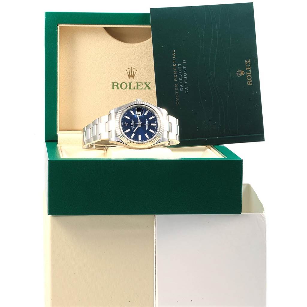 The Rolex Datejust 41 116334 Men's Stainless Steel Blue Dial 116334 Men's Stainless Steel Blue Dial watch is displayed in its opened case with a booklet beside it.