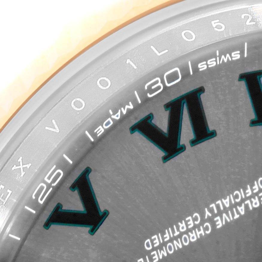 This close-up of the Rolex Datejust 41 126333 Men's Steel and Gold (two tone) Grey Dial 126333 Men's Steel and Gold (two tone) Grey Dial watch shows a part of the dial and bezel, including numerals and the "Swiss Made" inscription.