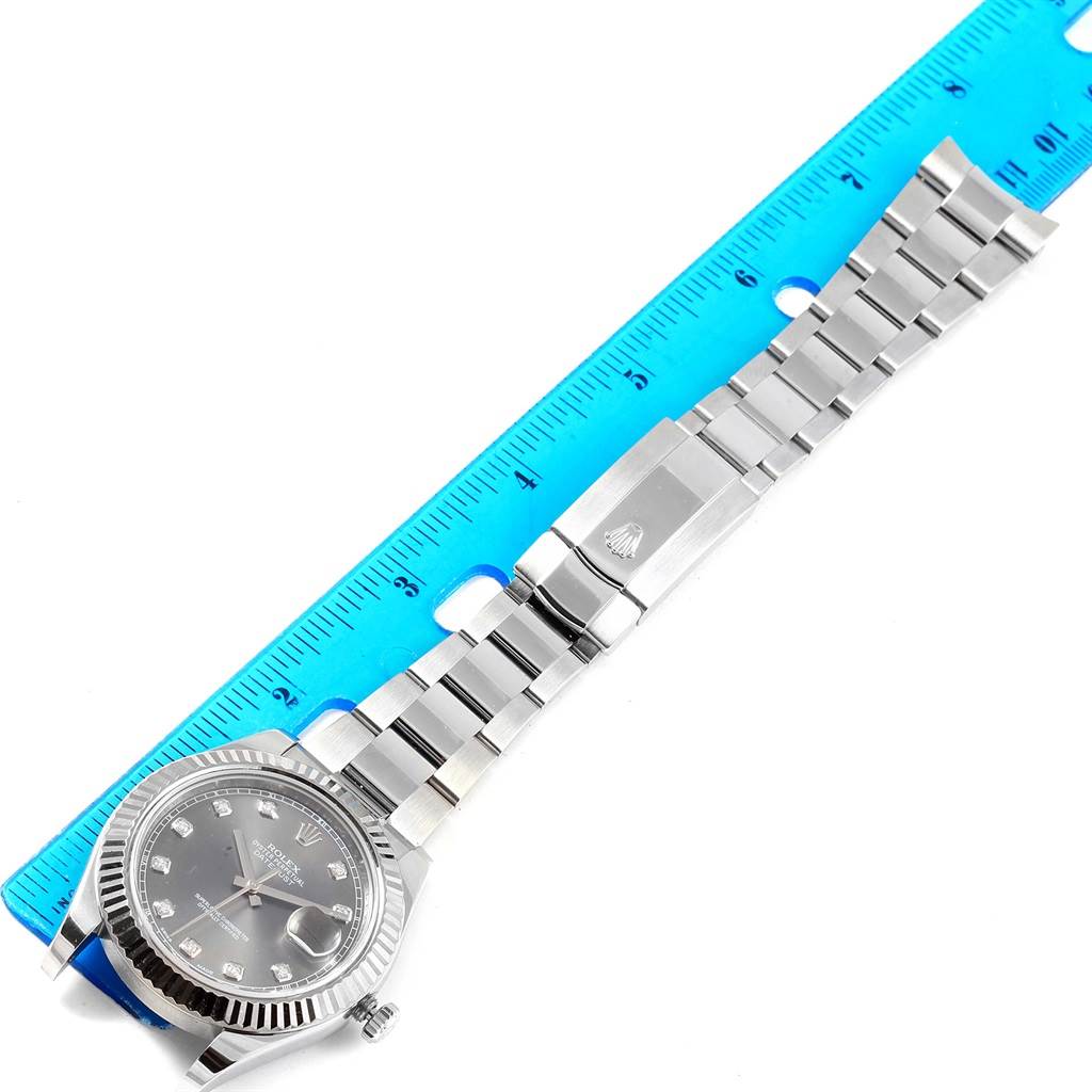 The image shows a top-down view of a Rolex Datejust 41 116334 Men's Stainless Steel Grey Dial 116334 Men's Stainless Steel Grey Dial watch with its band extended next to a ruler.