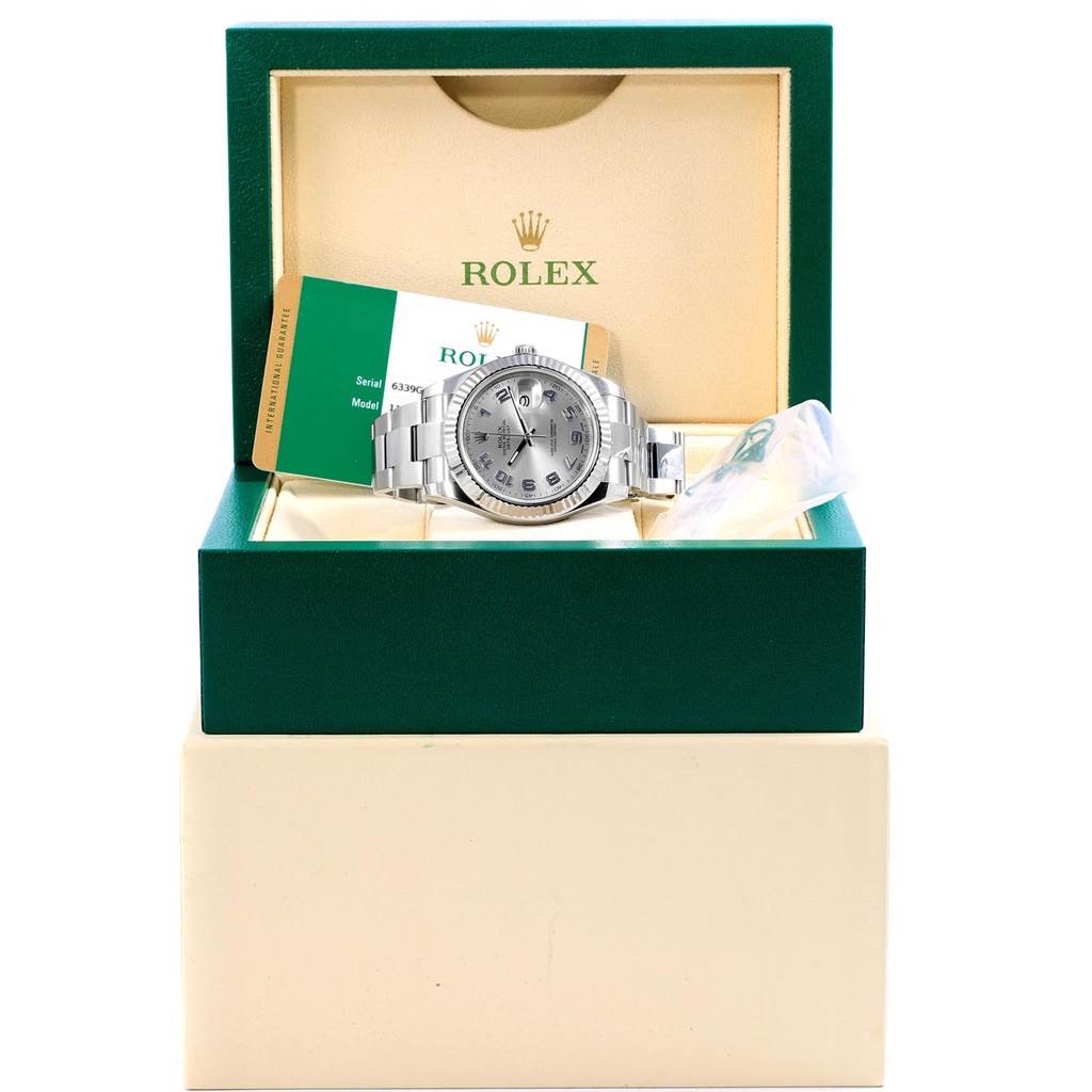 The Rolex Datejust 41 116334 Men's Stainless Steel Grey Dial 116334 Men's Stainless Steel Grey Dial watch is displayed in its open box, with accompanying warranty card and tags.