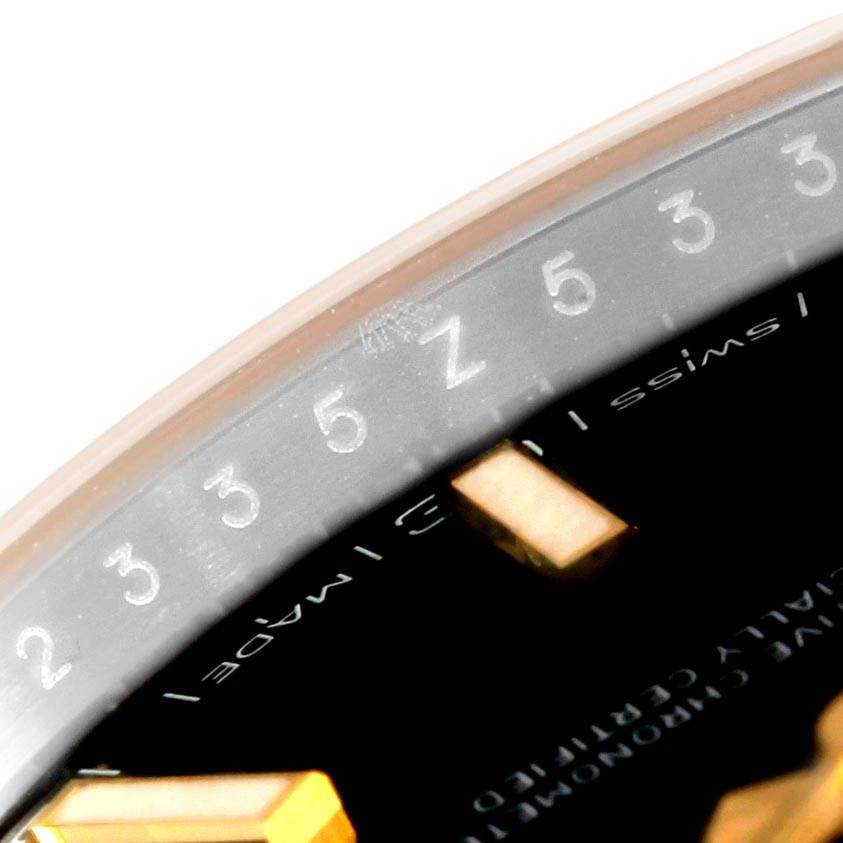 Close-up of the bezel and part of the dial of a Rolex Datejust 41 126303 Men's Steel and Gold (two tone) Black Dial 126303 Men's Steel and Gold (two tone) Black Dial watch, showing the numbers and Swiss certification text.