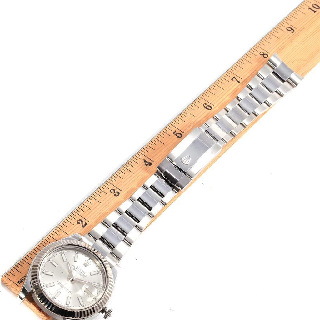 The image shows a Rolex Datejust 41 116334 Men's Stainless Steel Silver Dial 116334 Men's Stainless Steel Silver Dial watch laid flat beside a ruler, displaying its face and metal bracelet.