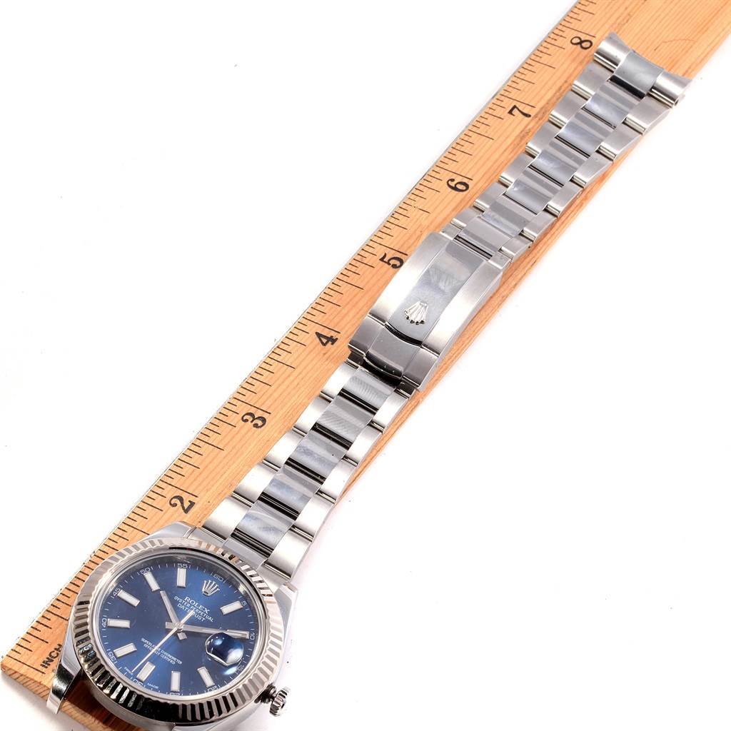 The image shows a Rolex Datejust 41 116334 Men's Stainless Steel Blue Dial 116334 Men's Stainless Steel Blue Dial watch laid flat next to a ruler, highlighting the face, bracelet, and clasp.