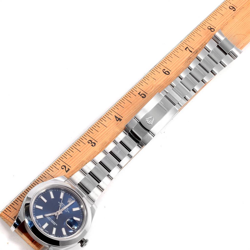 The image shows a Rolex Datejust 41 116300 Men's Stainless Steel Blue Dial 116300 Men's Stainless Steel Blue Dial watch laid flat next to a ruler, displaying the face, bracelet, and clasp.