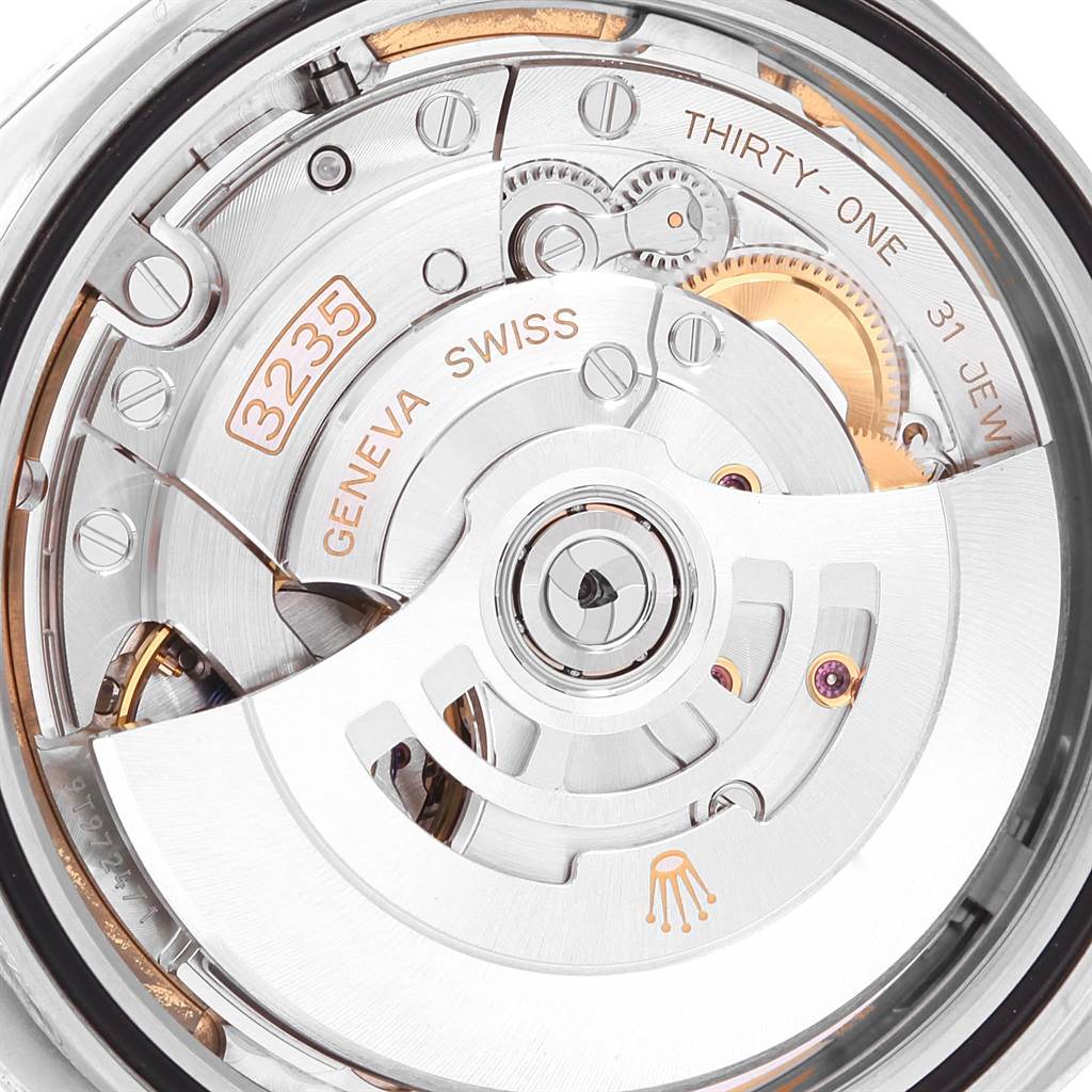 The image shows the internal mechanism of a Rolex Datejust 41 126300 Men's Stainless Steel White Dial 126300 Men's Stainless Steel White Dial watch, viewed from the back, highlighting the rotor, gears, and inscriptions.