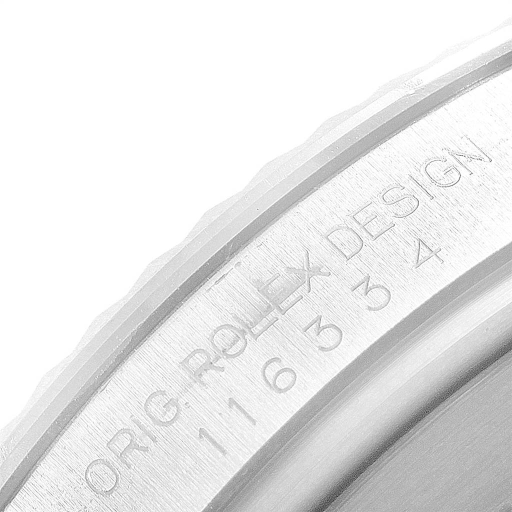 This close-up image of the Rolex Datejust 41 116334 Men's Stainless Steel Silver Dial 116334 Men's Stainless Steel Silver Dial watch shows the engraved bezel with the text "ORIG ROLEX DESIGN" and part of the model number.