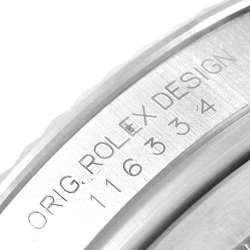 This close-up image of the Rolex Datejust 41 116334 Men's Stainless Steel Blue Dial 116334 Men's Stainless Steel Blue Dial shows an engraving on the inner bezel.