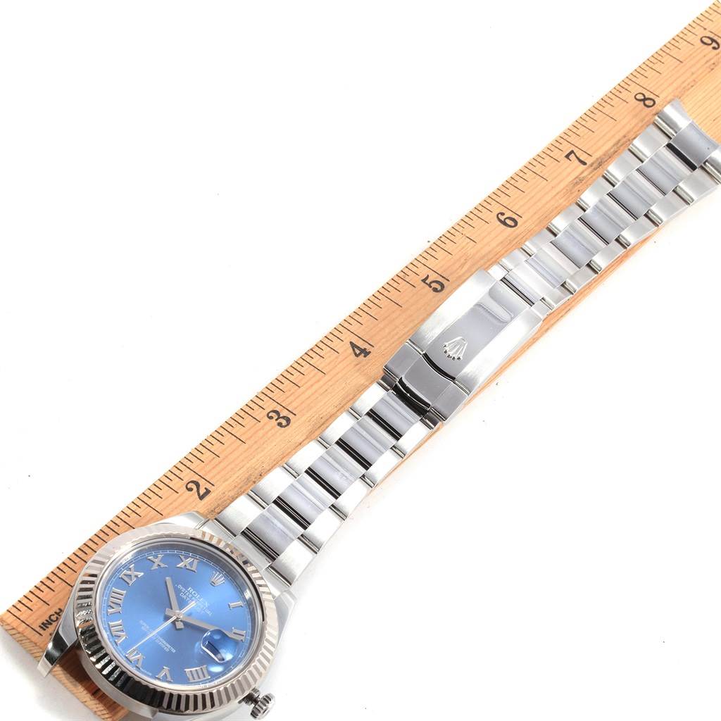 The Rolex Datejust 41 116334 Men's Stainless Steel Blue Dial 116334 Men's Stainless Steel Blue Dial watch is shown from a top view, highlighting the face, bezel, bracelet, and clasp beside a ruler for scale.