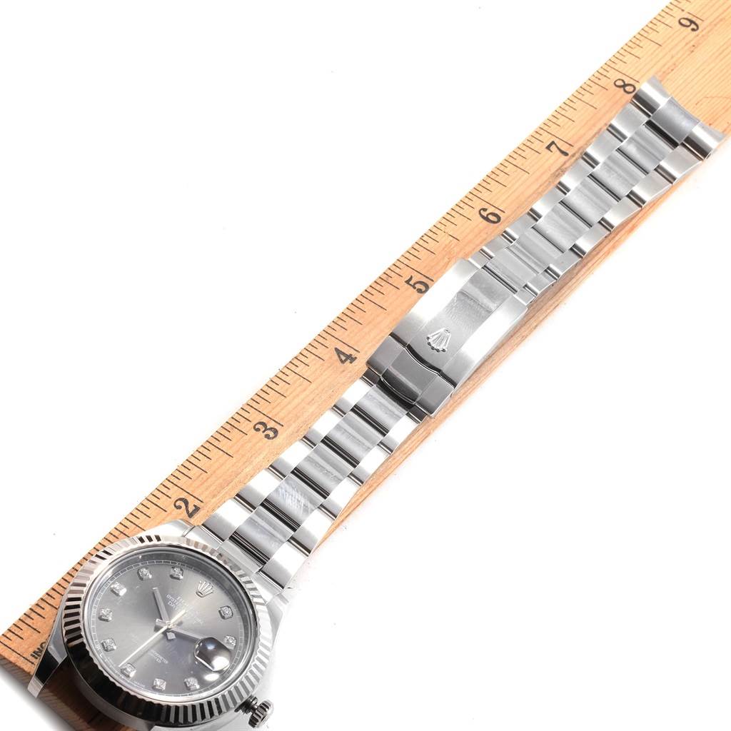 This image shows a side view of the Rolex Datejust 41 116334 Men
s Stainless Steel Grey Dial 116334 Men
s Stainless Steel Grey Dial watch, highlighting its face, bracelet, and clasp measured against a ruler.