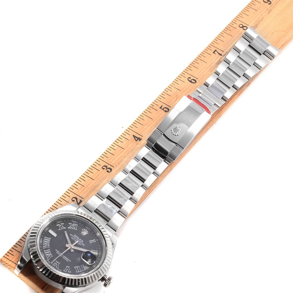 The Rolex Datejust 41 116334 Men
s Stainless Steel Grey Dial 116334 Men
s Stainless Steel Grey Dial watch is shown from above, displaying the face, bezel, and entire bracelet alongside a ruler for scale.