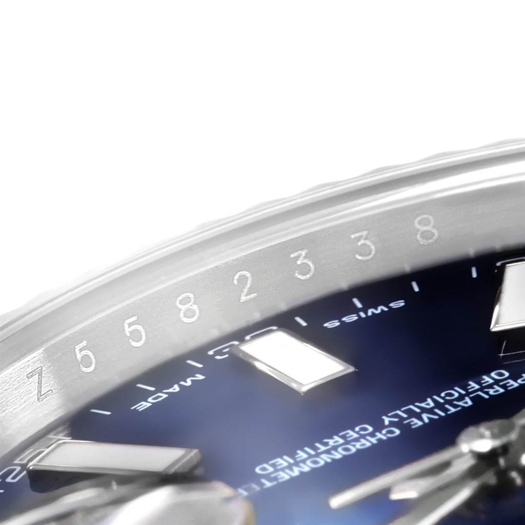 This close-up image of a Rolex Datejust 41 116334 Men's Stainless Steel Blue Dial 116334 Men's Stainless Steel Blue Dial watch shows part of the dial and the inner bezel with engraved numbers.