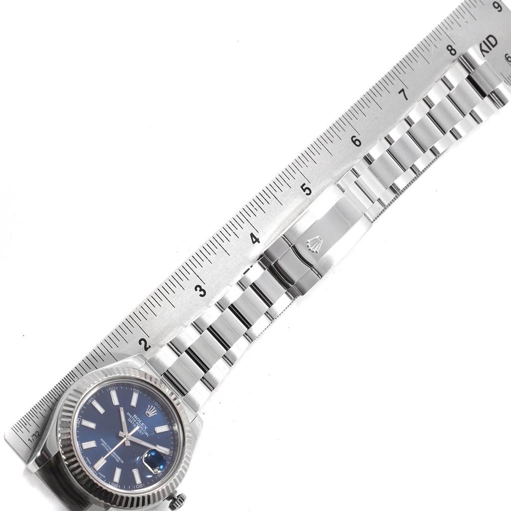 The image shows a top view of a Rolex Datejust 41 116334 Men's Stainless Steel Blue Dial 116334 Men's Stainless Steel Blue Dial, highlighting the watch face, bezel, and bracelet with a ruler for scale.