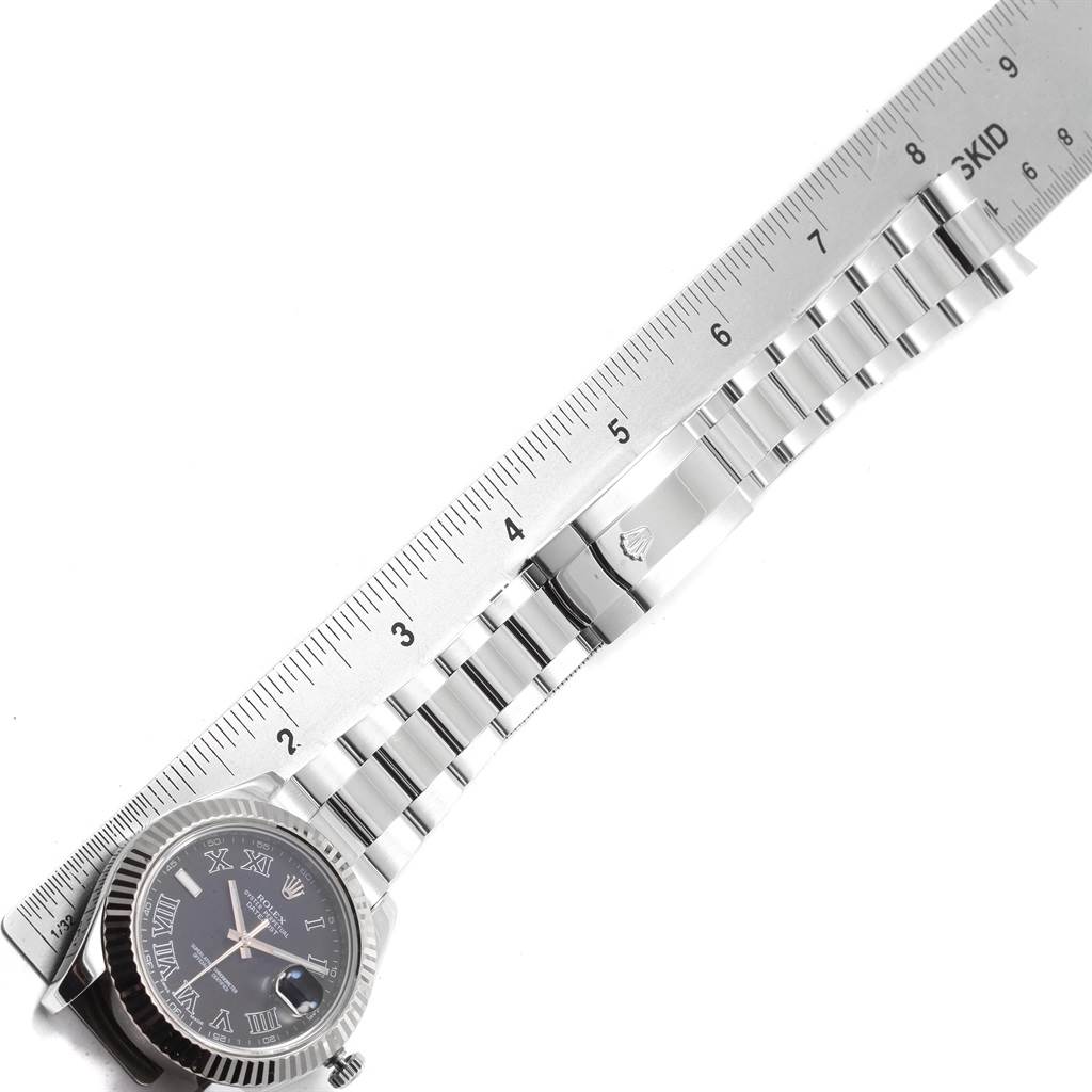 The image shows the Rolex Datejust 41 116334 Men's Stainless Steel Grey Dial 116334 Men's Stainless Steel Grey Dial watch laid flat alongside a ruler, displaying the face and bracelet.