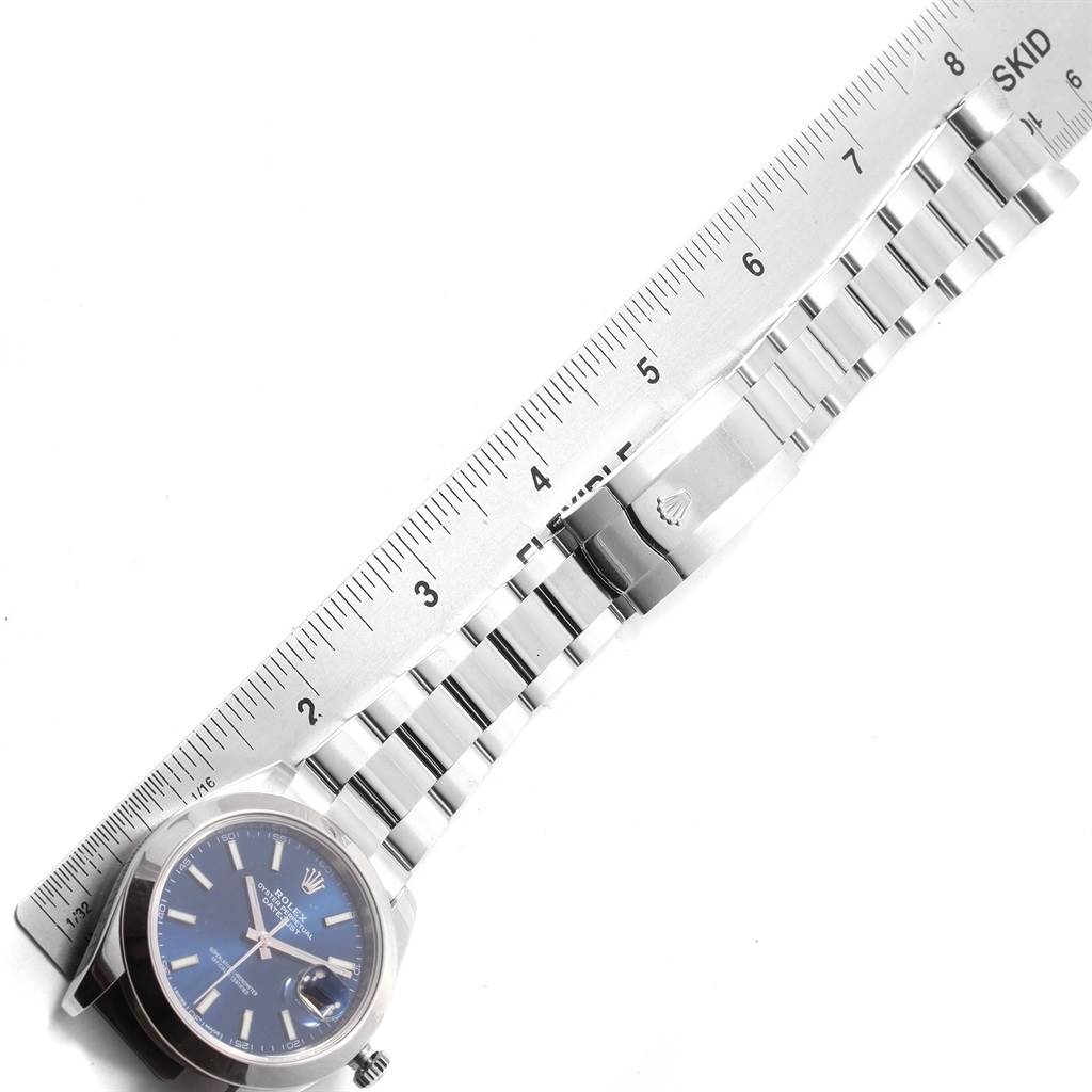 The image shows a Rolex Datejust 41 126300 Men's Stainless Steel Blue Dial 126300 Men's Stainless Steel Blue Dial watch with its bracelet laid next to a ruler for measurement.