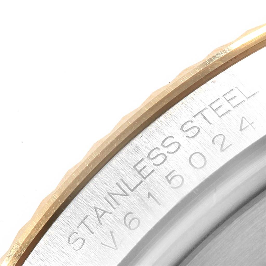 This close-up image of the Rolex Datejust 41 116333 Men's Steel and Gold (two tone) Grey Dial 116333 Men's Steel and Gold (two tone) Grey Dial shows part of the fluted bezel and the serial number engraved on the stainless steel side.