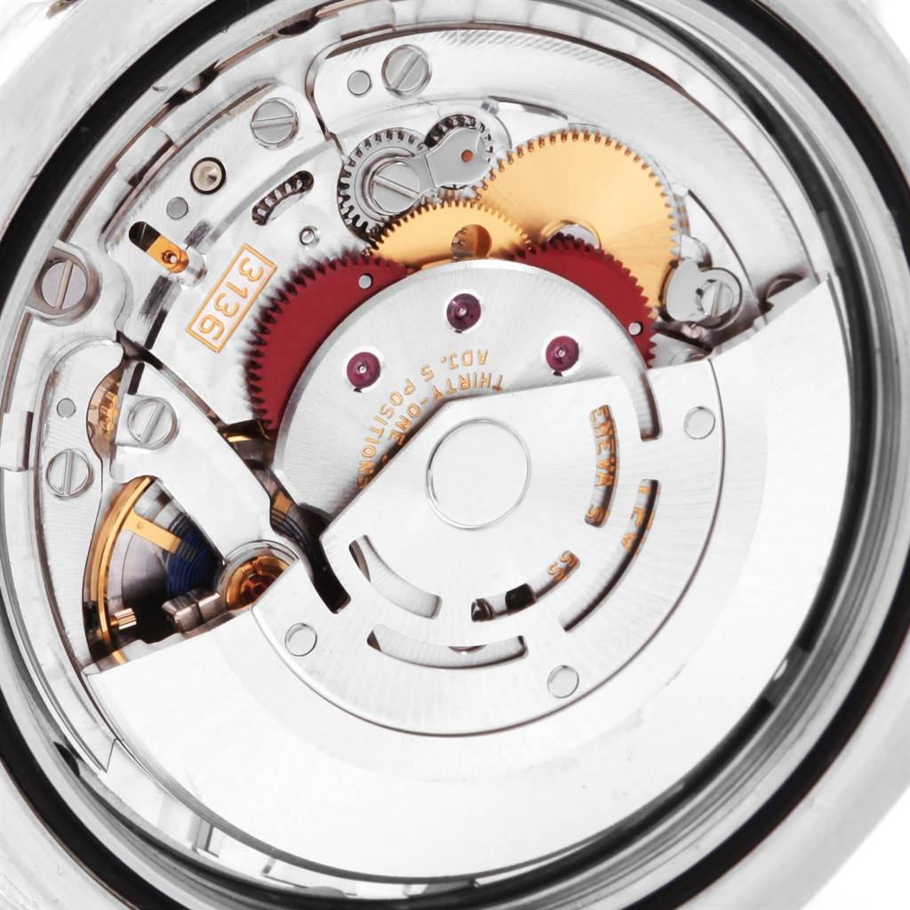 The image shows a close-up of the movement mechanism of a Rolex Datejust 41 116300 Men
s Stainless Steel Blue Dial 116300 Men
s Stainless Steel Blue Dial watch.