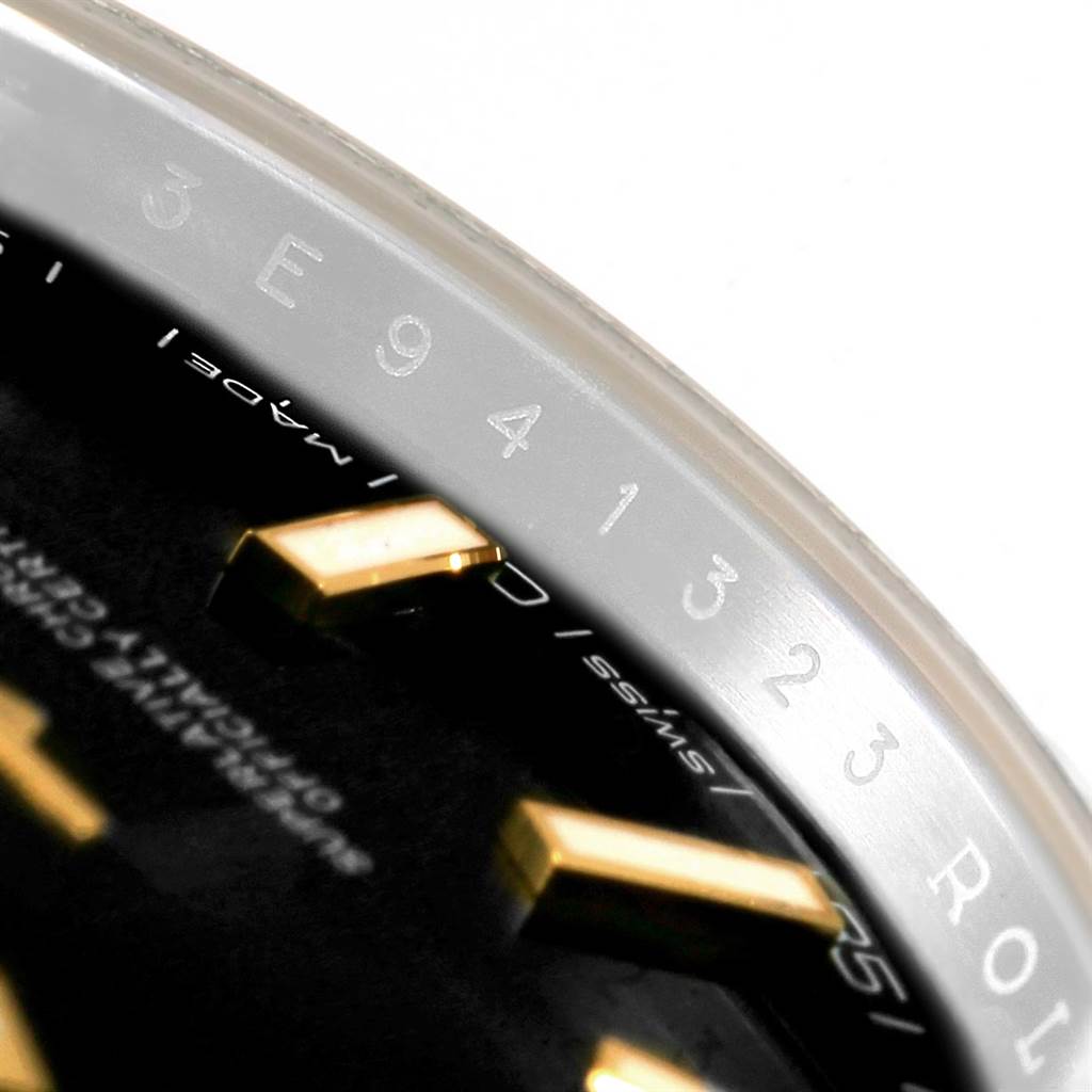 The image displays part of the dial and the serial number engraving on the inner bezel of a Rolex Datejust 41 126333 Men's Steel and Gold (two tone) Black Dial 126333 Men's Steel and Gold (two tone) Black Dial watch.