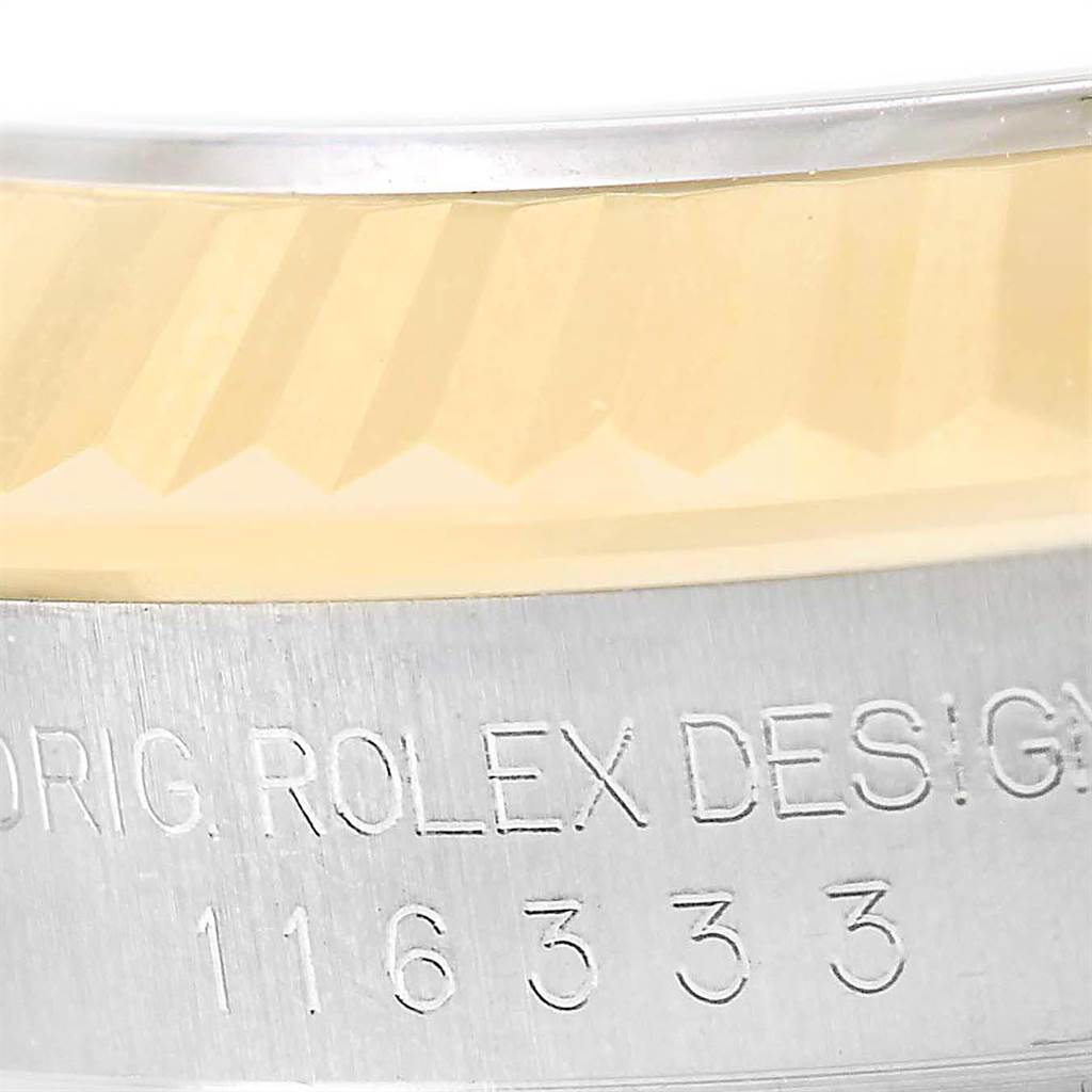 This image shows a close-up view of the fluted bezel and engraved case side of the Rolex Datejust 41 116333 Men's Steel and Gold (two tone) Black Dial 116333 Men's Steel and Gold (two tone) Black Dial model.