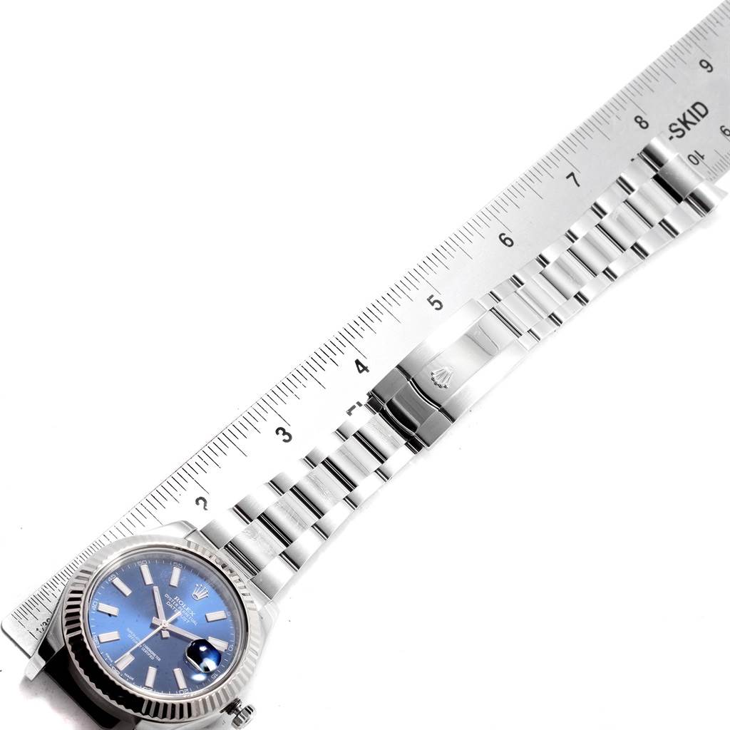 The image shows the dial and bracelet of a Rolex Datejust 41 116334 Men
s Stainless Steel Blue Dial 116334 Men
s Stainless Steel Blue Dial watch, alongside a ruler for scale.