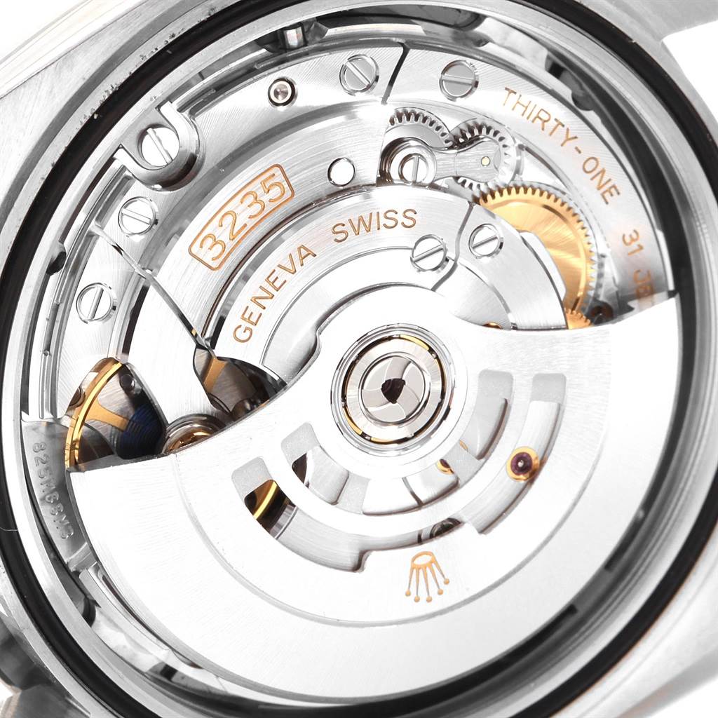 The image shows the internal mechanism of a Rolex Datejust 41 126300 Men
s Stainless Steel Grey Dial 126300 Men
s Stainless Steel Grey Dial watch at a close-up angle, highlighting the movement components.