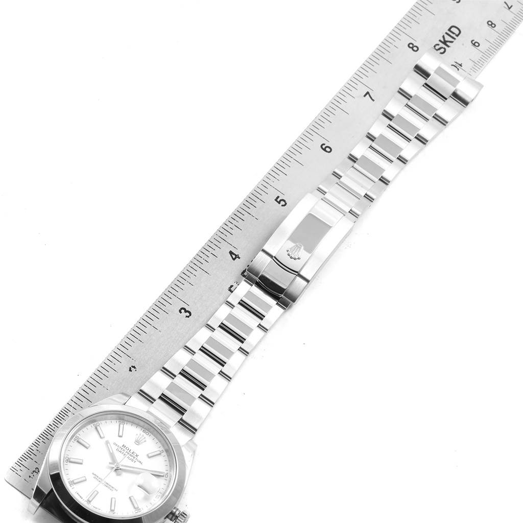 The image shows a Rolex Datejust 41 126300 Men's Stainless Steel White Dial 126300 Men's Stainless Steel White Dial watch laid flat with a stainless steel bracelet and a ruler for measurement.