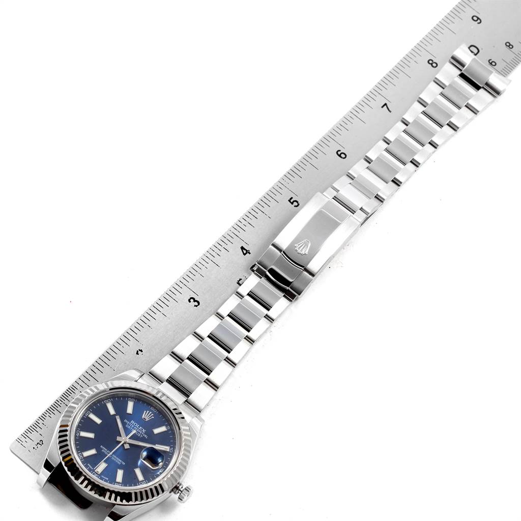 The image shows a Rolex Datejust 41 116334 Men's Stainless Steel Blue Dial 116334 Men's Stainless Steel Blue Dial laid flat next to a ruler, highlighting the face, bezel, and bracelet.