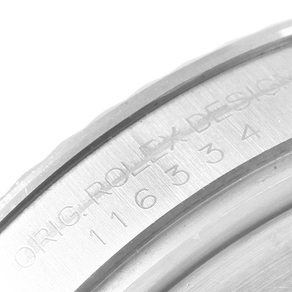 This is a close-up shot of the case back rim of a Rolex Datejust 41 116334 Men's Stainless Steel Blue Dial 116334 Men's Stainless Steel Blue Dial watch, showing engraved text details.